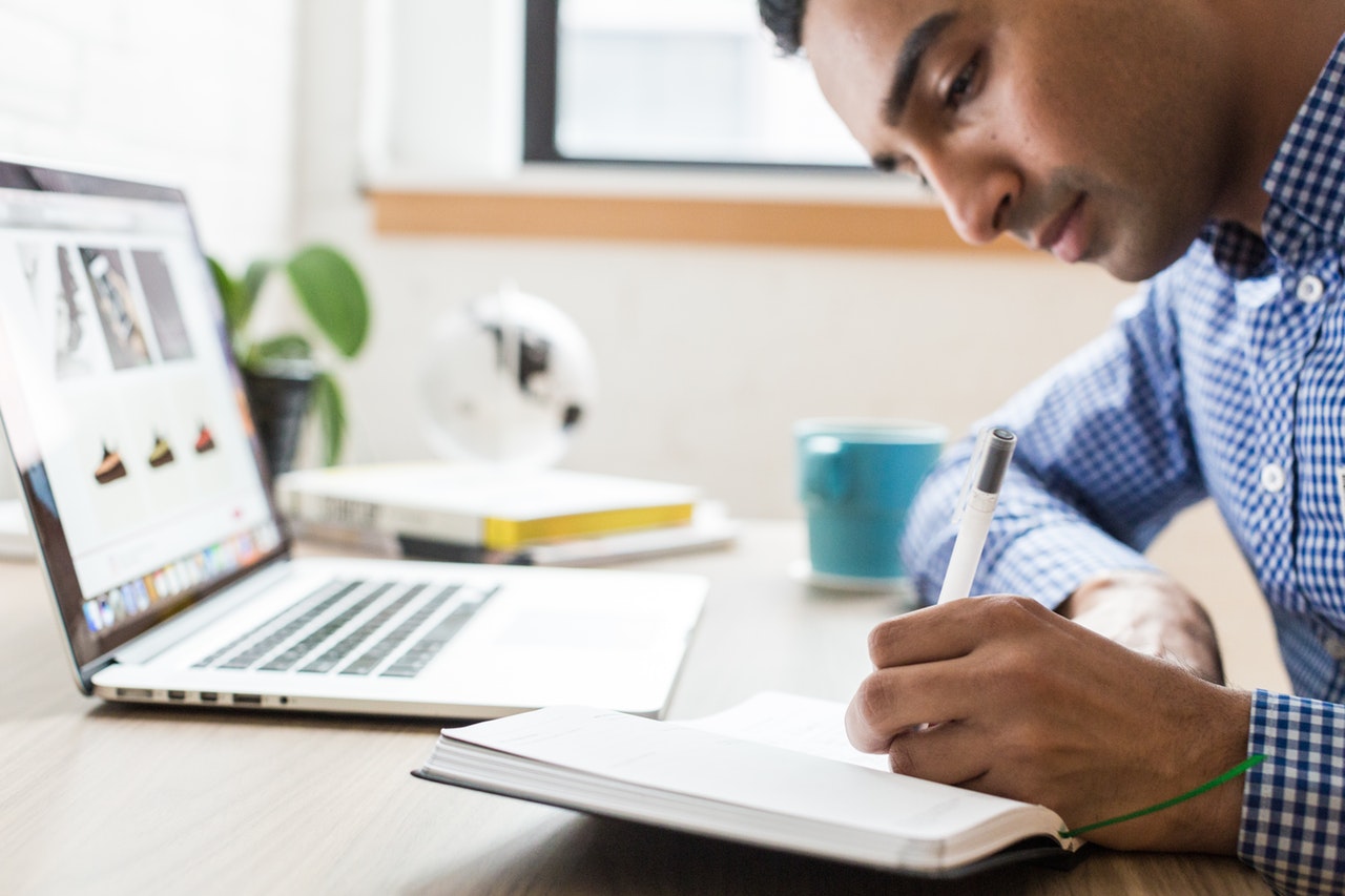 man-writing-notebook