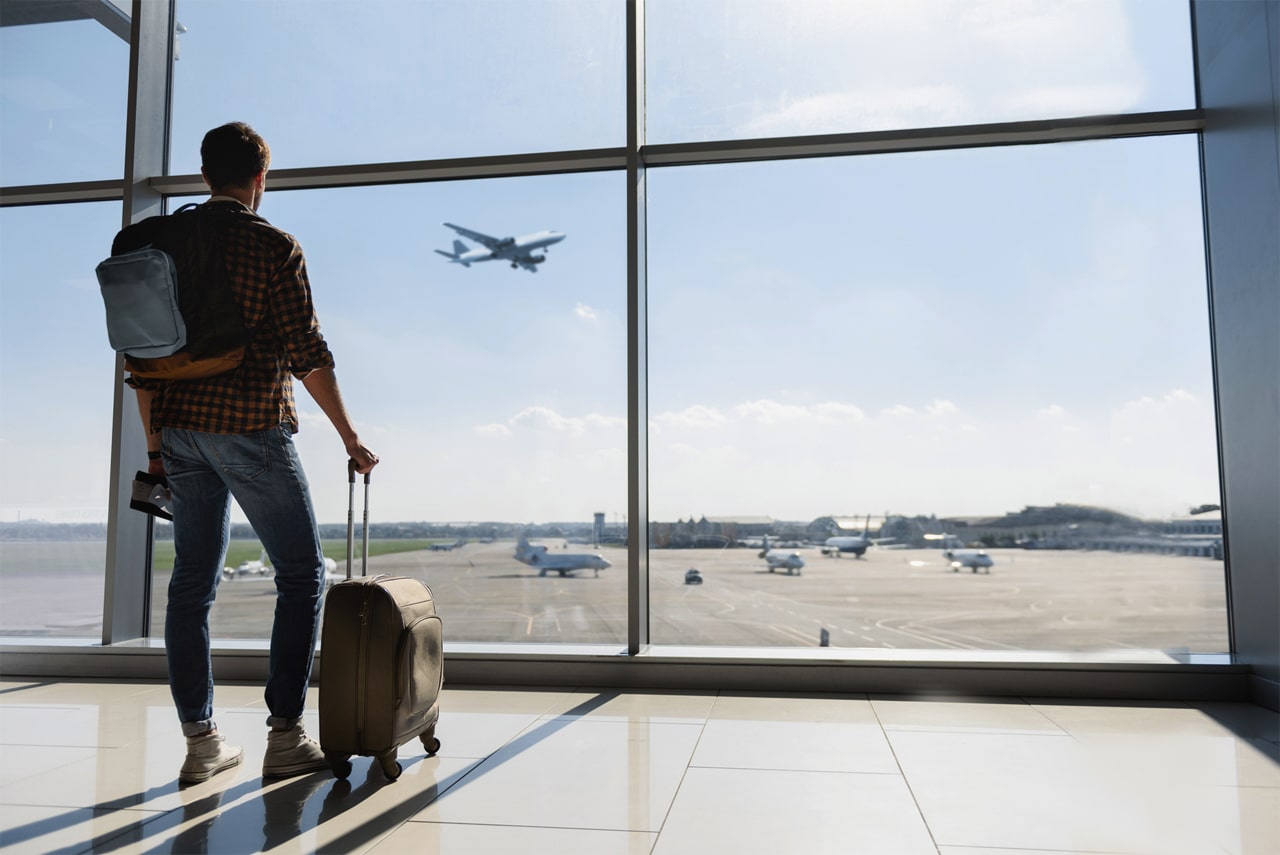 man-standing-airport-1280-min